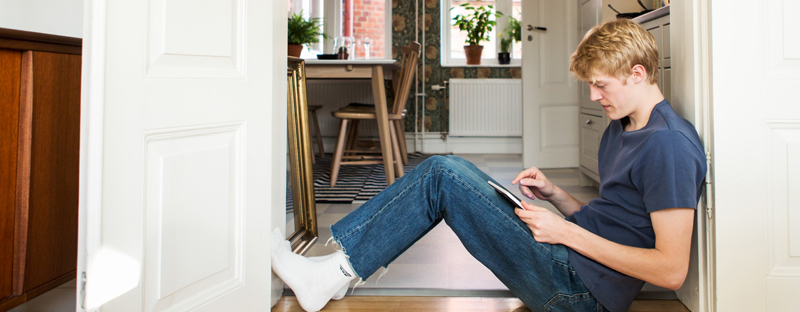 man researching home buying options on tablet