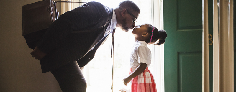 dad kissing daughter goodbye in new home