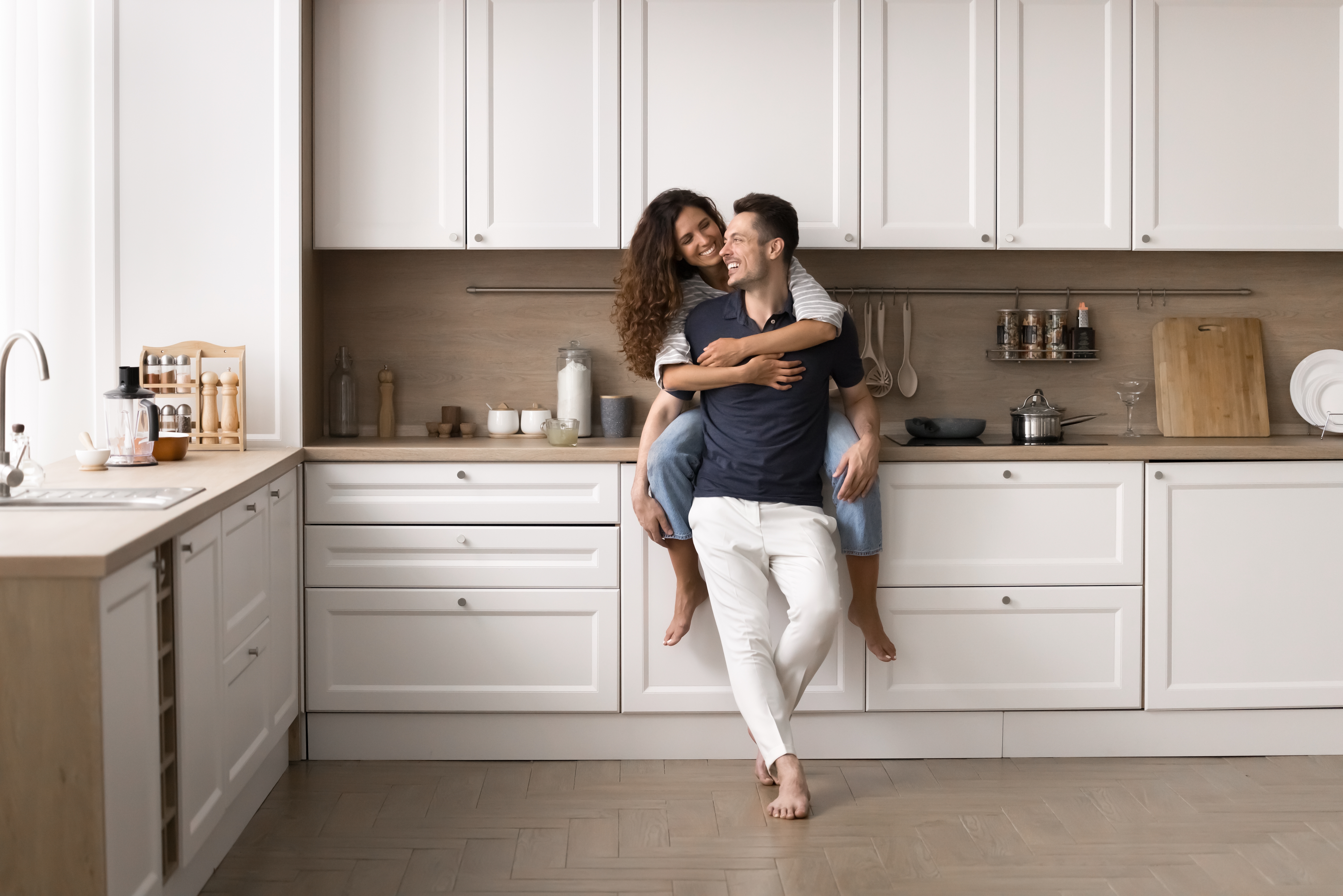 happy couple enjoying newly remodeled home kitchen