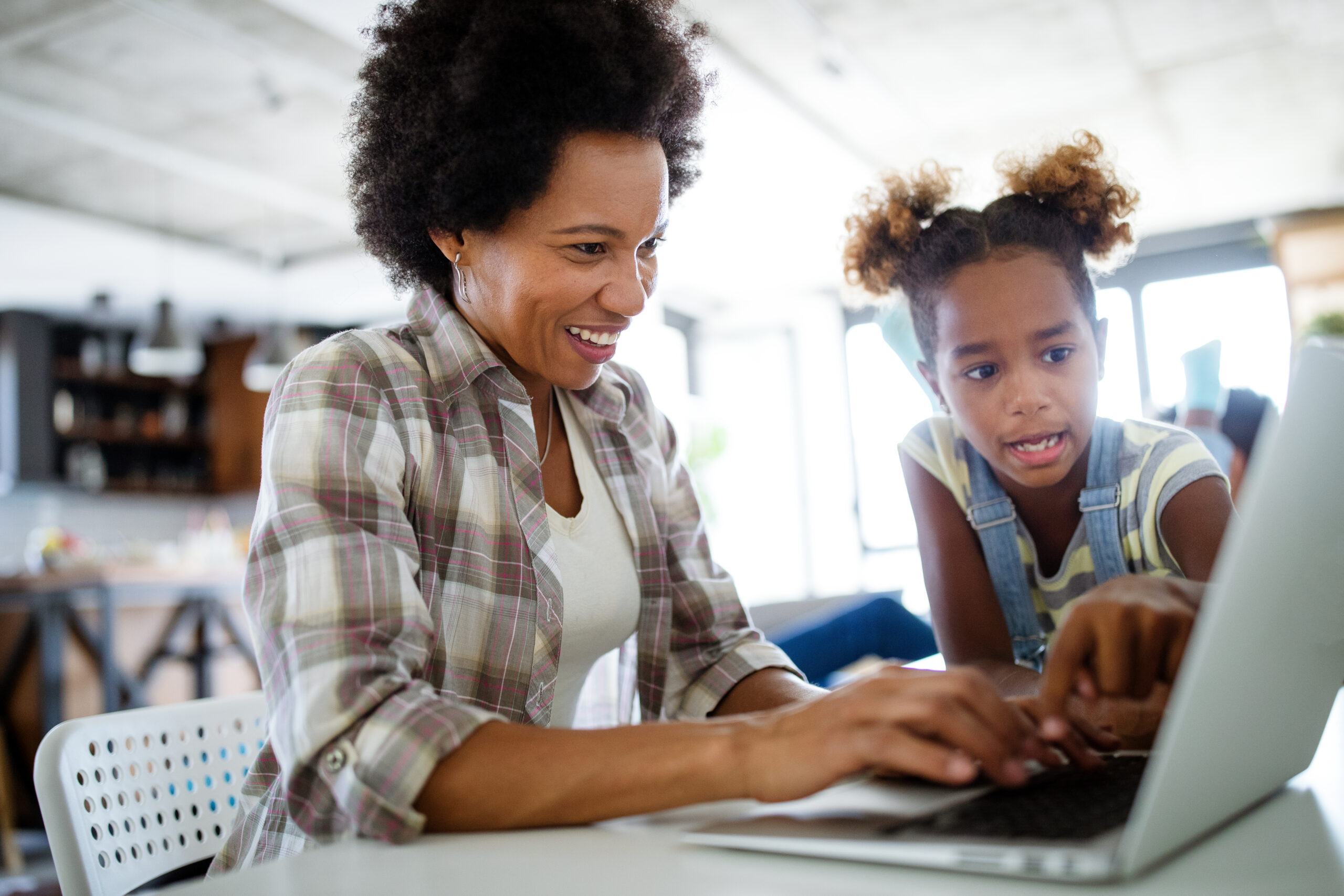 mother and daughter review a website for an online mortgage lender